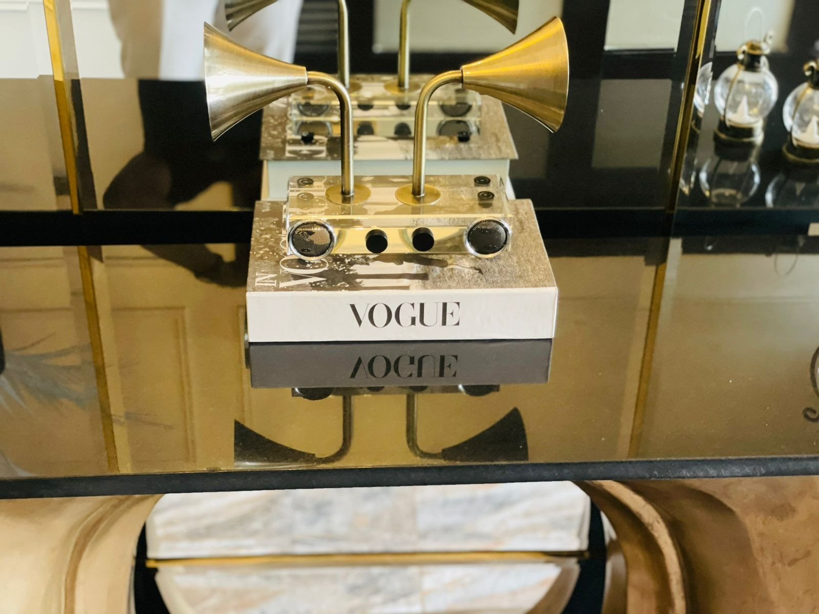 Brass speaker styling detail on Vogue book